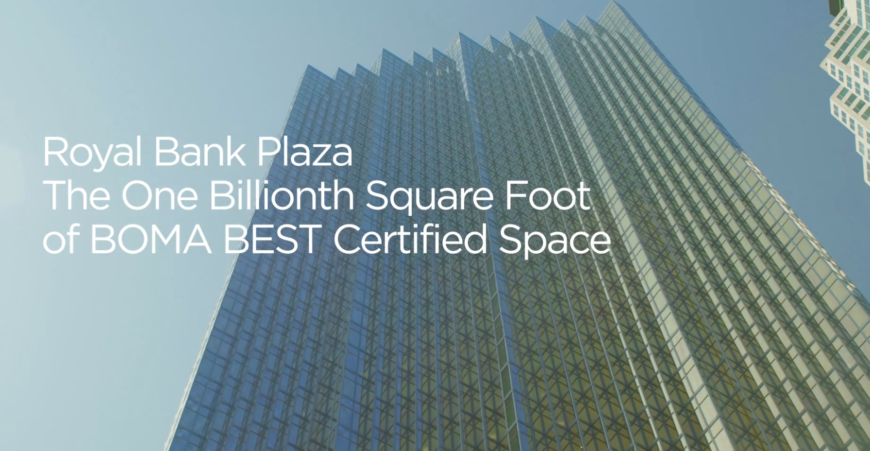 BOMA BEST - The towering glass skyscraper proudly marks Royal Bank Plaza as the one billionth square foot of BOMA BEST certified space, set against a backdrop of clear blue sky.